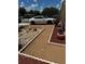 Spacious driveway with attractive landscaping featuring stone and potted plants at 105 Cattail Ct, Kissimmee, FL 34743