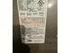Close up view of the HVAC equipment label with model and serial numbers at 105 Cattail Ct, Kissimmee, FL 34743