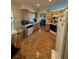 Bright kitchen featuring wood cabinets, white appliances, and tile flooring with an adjacent dining area at 105 Cattail Ct, Kissimmee, FL 34743