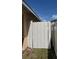 Side yard featuring a white-painted wooden gate in a residential fenced yard at 105 Cattail Ct, Kissimmee, FL 34743