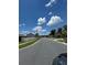 A serene street view showcasing the neighborhood's well-manicured lawns and sidewalks at 105 Cattail Ct, Kissimmee, FL 34743