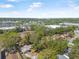 An aerial showing the house and landscaping among mature trees in a residential area at 1432 Mollie Rd, Daytona Beach, FL 32114