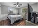 Cozy bedroom with hardwood floors, ceiling fan, and natural light at 1432 Mollie Rd, Daytona Beach, FL 32114
