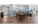 Open-concept dining room boasts modern design elements and beautiful laminate flooring at 1432 Mollie Rd, Daytona Beach, FL 32114