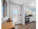 Inviting entryway with glass paneled door, light-colored walls, and wood-look floors at 1432 Mollie Rd, Daytona Beach, FL 32114