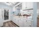 Bright kitchen featuring white cabinets, stainless steel appliances, and an open view to the living area at 1432 Mollie Rd, Daytona Beach, FL 32114
