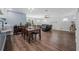 Open-concept dining and living area with hardwood floors, dining table, and comfortable seating at 1432 Mollie Rd, Daytona Beach, FL 32114