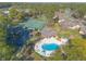 Aerial view of community amenities including a pool, tennis courts, and lush green landscaping at 206 Sage Brush Trl, Ormond Beach, FL 32174