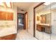 Bright bathroom featuring a walk-in shower, marble vanity, and mirrored closet doors at 206 Sage Brush Trl, Ormond Beach, FL 32174