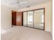 Bright bedroom featuring mirrored closet doors, a ceiling fan, and neutral-toned walls at 206 Sage Brush Trl, Ormond Beach, FL 32174
