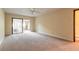Bedroom with neutral carpeting and sliding glass door leading to the patio at 206 Sage Brush Trl, Ormond Beach, FL 32174
