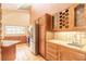 Kitchen with oak cabinetry, tile countertops, and stainless-steel appliances at 206 Sage Brush Trl, Ormond Beach, FL 32174