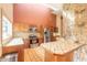 Spacious kitchen with stainless steel appliances, tile countertops, and wooden cabinetry at 206 Sage Brush Trl, Ormond Beach, FL 32174