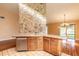 Kitchen island with sink, tiled countertops, and stainless steel dishwasher at 206 Sage Brush Trl, Ormond Beach, FL 32174