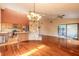 Open-concept living space with a stone fireplace and adjacent kitchen bar area at 206 Sage Brush Trl, Ormond Beach, FL 32174