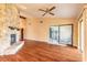 Open living area with a stone fireplace, wood floors, and sliding glass doors at 206 Sage Brush Trl, Ormond Beach, FL 32174