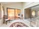Enclosed patio featuring sliding glass doors, stone fireplace and cozy seating at 206 Sage Brush Trl, Ormond Beach, FL 32174