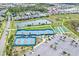 Aerial view of community amenities including tennis, bocce ball, pickleball, and community ponds, and nearby homes at 251 Island Breeze Ave, Daytona Beach, FL 32124