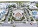 Aerial shot of town center with shops, a central stage, and golf cart parking, surrounded by mature landscaping at 251 Island Breeze Ave, Daytona Beach, FL 32124