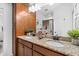 Bathroom featuring a double vanity with granite countertop and wooden cabinets at 251 Island Breeze Ave, Daytona Beach, FL 32124