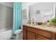 Bathroom featuring a single vanity with granite countertops, a tub, and a blue shower curtain at 251 Island Breeze Ave, Daytona Beach, FL 32124