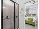 Modern bathroom with a glass-enclosed shower and access to the Primary bedroom at 251 Island Breeze Ave, Daytona Beach, FL 32124