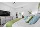 Bright bedroom featuring a king bed, white linens, and a TV on the dresser at 251 Island Breeze Ave, Daytona Beach, FL 32124