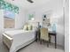 Cozy bedroom with a desk, a white quilt, and a floral valance above the window at 251 Island Breeze Ave, Daytona Beach, FL 32124
