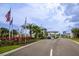 Inviting community entrance with lush landscaping, flags, and a welcoming covered entryway at 251 Island Breeze Ave, Daytona Beach, FL 32124