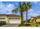 Charming home with a two-car garage, lush landscaping, and a paver driveway at 251 Island Breeze Ave, Daytona Beach, FL 32124