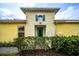 Quaint, sun-filled, one-story home with a blue door and shuttered window offers charm and curb appeal at 251 Island Breeze Ave, Daytona Beach, FL 32124