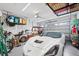Spacious garage featuring a white Corvette, golf cart, motorcycle, and overhead storage racks at 251 Island Breeze Ave, Daytona Beach, FL 32124