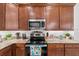 This kitchen boasts rich wood cabinetry, granite countertops, and stainless steel appliances at 251 Island Breeze Ave, Daytona Beach, FL 32124