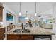 The open kitchen features a central island with granite counters that opens to the living and dining rooms at 251 Island Breeze Ave, Daytona Beach, FL 32124