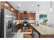A bright eat-in kitchen showcases wood cabinets, granite countertops, an island and stainless steel appliances at 251 Island Breeze Ave, Daytona Beach, FL 32124