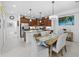 Bright eat-in kitchen with center island, bar seating, stainless appliances, granite counters and modern lighting at 251 Island Breeze Ave, Daytona Beach, FL 32124