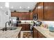 Spacious kitchen features granite counters, wooden cabinets, stainless steel appliances, and center island at 251 Island Breeze Ave, Daytona Beach, FL 32124