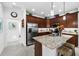 Modern eat-in kitchen featuring a center island with bar seating, granite countertops and stainless appliances at 251 Island Breeze Ave, Daytona Beach, FL 32124