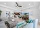 Open-concept living area showcases a neutral sofa, modern media center, and kitchen access at 251 Island Breeze Ave, Daytona Beach, FL 32124