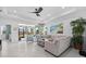 This bright living area has tile floors, a ceiling fan, modern decor, and sliding glass doors to the lanai at 251 Island Breeze Ave, Daytona Beach, FL 32124