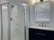Bathroom featuring a glass shower stall, vanity, and a bright window at 30 Azalea Dr, Ormond Beach, FL 32176