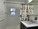 Bathroom with updated fixtures, vanity, and unique shower curtain at 30 Azalea Dr, Ormond Beach, FL 32176