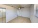 This bright bedroom includes neutral paint, tile floors, a ceiling fan, and windows for natural light at 30 Azalea Dr, Ormond Beach, FL 32176