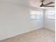 Bright bedroom featuring neutral paint, tile floors, a ceiling fan, and windows for natural light at 30 Azalea Dr, Ormond Beach, FL 32176