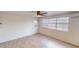 Bright bedroom featuring neutral paint, tile floors, a ceiling fan, and windows for natural light at 30 Azalea Dr, Ormond Beach, FL 32176