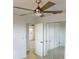 Bedroom view featuring a ceiling fan and a mirrored closet at 30 Azalea Dr, Ormond Beach, FL 32176