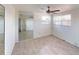 Bright bedroom featuring tile floors, mirrored closet and large window at 30 Azalea Dr, Ormond Beach, FL 32176
