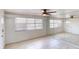A bedroom featuring white walls, a ceiling fan and a mirrored closet at 30 Azalea Dr, Ormond Beach, FL 32176