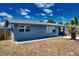 Side view of a charming single-story home with a well-maintained lawn and walkway at 30 Azalea Dr, Ormond Beach, FL 32176