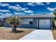 Charming single-story home with a garage and a well-maintained front yard with a palm tree at 30 Azalea Dr, Ormond Beach, FL 32176